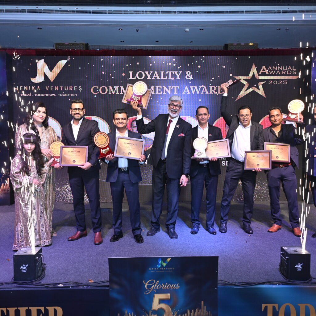 Team receiving awards at corporate event ceremony with stage setup and branding